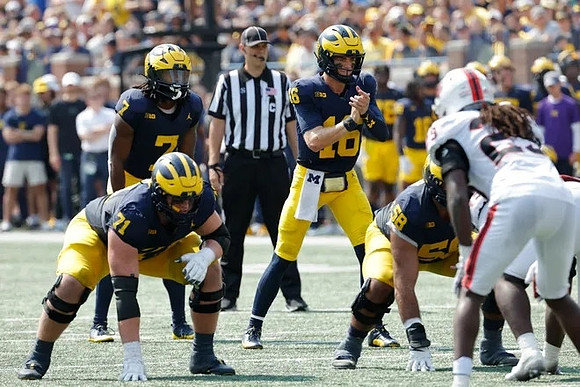 Donovan Edwards (7), Evan Link (71), Davis Warren (16), and Giovanni El-Hadi (58)