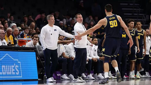 Dusty May, Vladislav Goldin (50), and Michigan Team