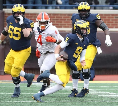 Zak Zinter (65), J.J. McCarthy (9), and Olusegun Oluwatimi (55)