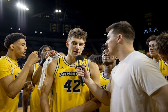 Will Tschetter (42) and Michigan Team