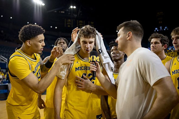 Will Tschetter (42) and Michigan Team
