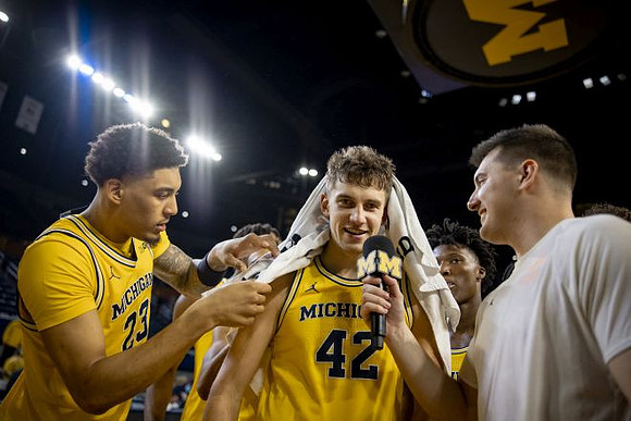Will Tschetter (42) and Michigan Team