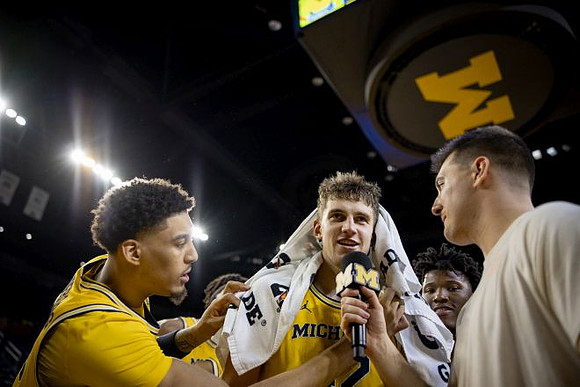 Will Tschetter (42) and Michigan Team