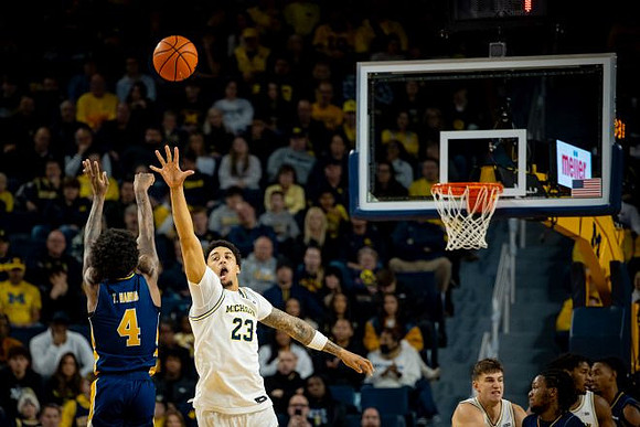 Yaxel Lendeborg (23), Will Tschetter (42), and Morez Johnson Jr. (21)