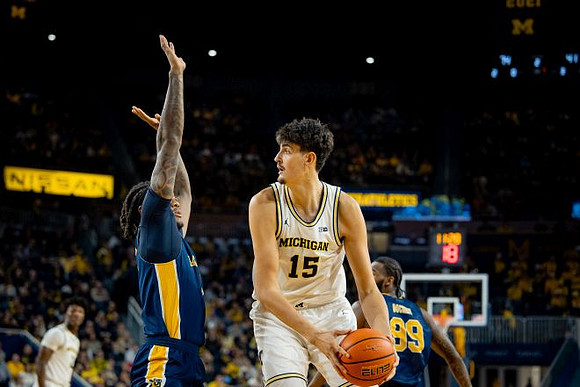 L.J. Cason (2) and Aday Mara (15)