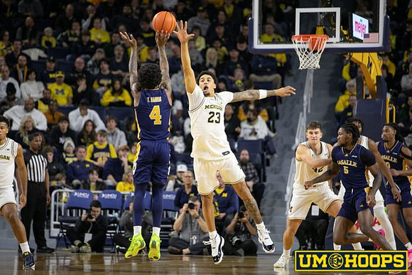 Trey McKenney (1), Yaxel Lendeborg (23), Will Tschetter (42), and Morez Johnson Jr. (21)