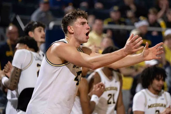 Will Tschetter (42) and Michigan Team
