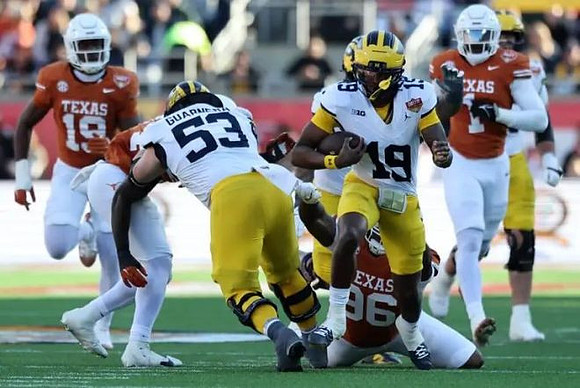 Jake Guarnera (53) and Bryce Underwood (19)