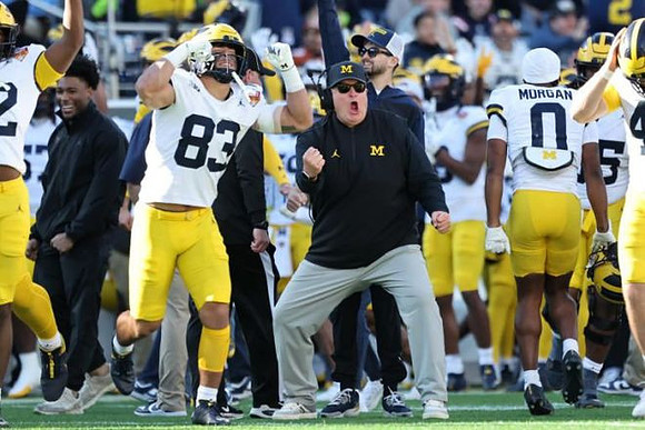Acting Head Coach Biff Poggi and Michigan Team