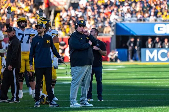 Acting Head Coach Biff Poggi and Michigan Team