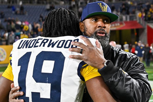 Bryce Underwood (19) and Charles Woodson