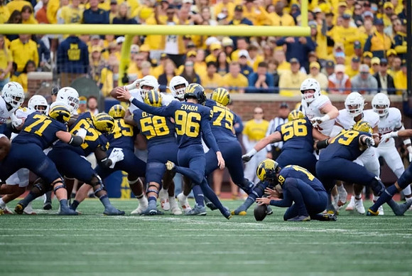 Dominic Zvada (96), Tommy Doman (19), and Michigan Team