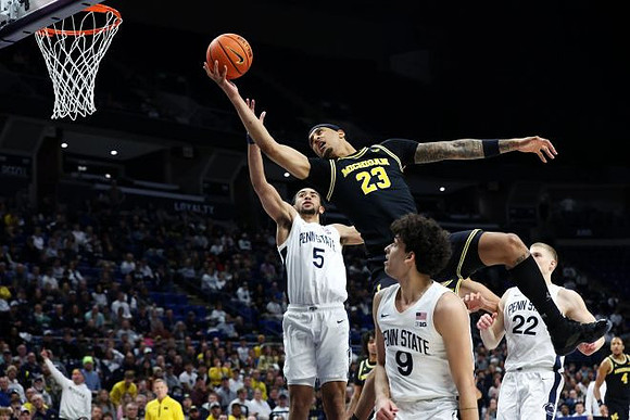 Dusty May, Yaxel Lendeborg (23), and Nimari Burnett (4)