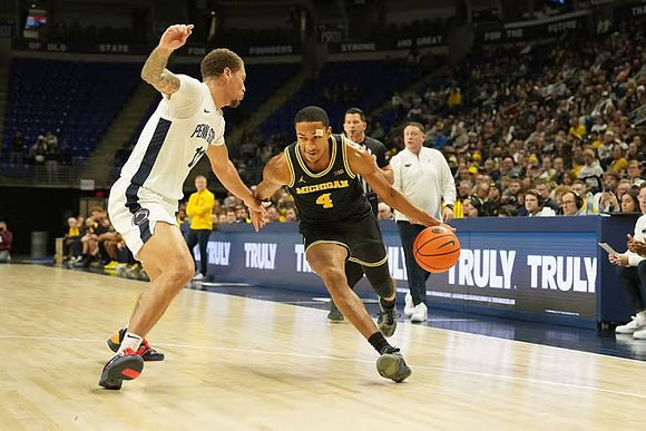 Nimari Burnett (4) and Penn State Head Coach Mike Rhoades