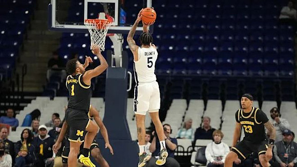 Trey McKenney (1) and Yaxel Lendeborg (23)