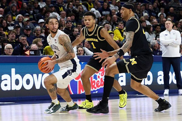 Trey McKenney (1) and Yaxel Lendeborg (23)