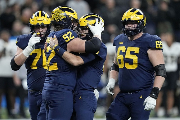 Ryan Hayes (76), Karsen Barnhart (52), J.J. McCarthy (9), and Zak Zinter (65)