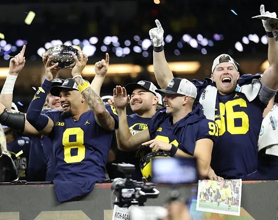 Ronnie Bell (8), Jake Moody (13), Brad Robbins (91), Luke Schoonmaker (86), and Big Ten Championship Trophy