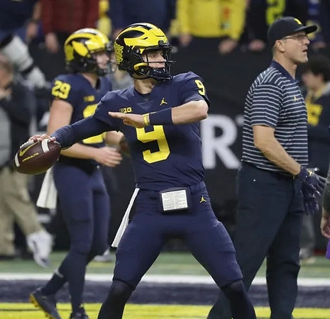 Joey Velazquez (29), J.J. McCarthy (9), and Jim Harbaugh