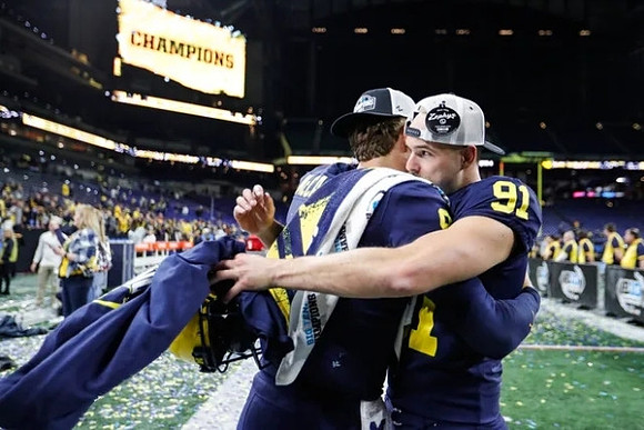 J.J. McCarthy (9) and Brad Robbins (91)