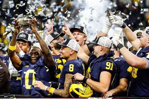 Mike Sainristil (0), Ronnie Bell (8), Brad Robbins (91), Michigan Team, and Big Ten Championship Trophy