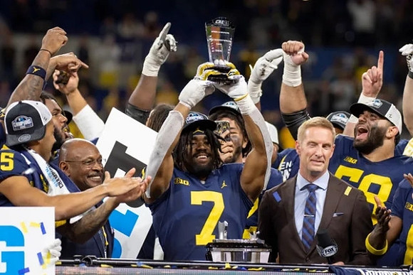 Donovan Edwards (7), Michigan Team, and Big Ten Championship MVP Trophy
