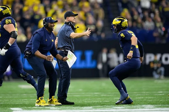 Zak Zinter (65), Jim Harbaugh, and J.J. McCarthy (9)