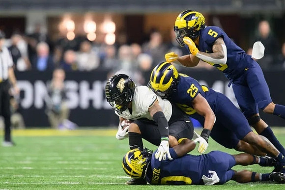 Mike Sainristil (0), Junior Colson (25), and DJ Turner (5)