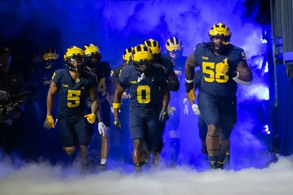 DJ Turner (5), Mike Sainristil (0), and Mazi Smith (58)