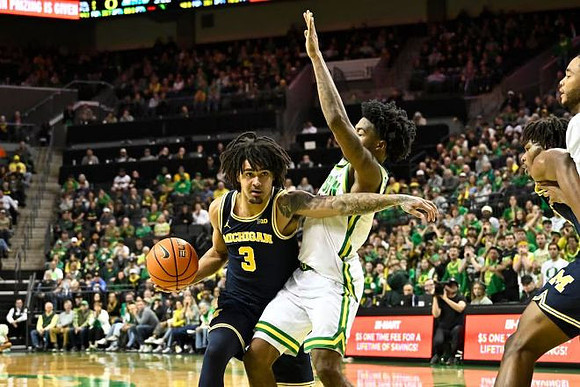 Elliot Cadeau (3) and Morez Johnson Jr. (21)