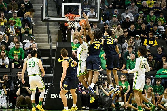 Will Tschetter (42), Morez Johnson Jr. (21), and Yaxel Lendeborg (23)