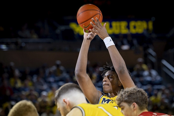 Hunter Dickinson (1) and Tarris Reed Jr. (32)