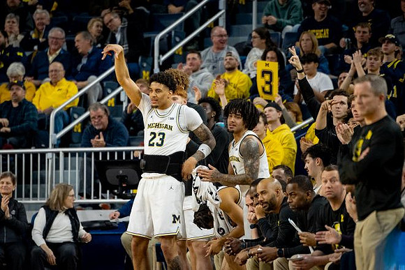 Yaxel Lendeborg (23), Dusty May, and Michigan Team