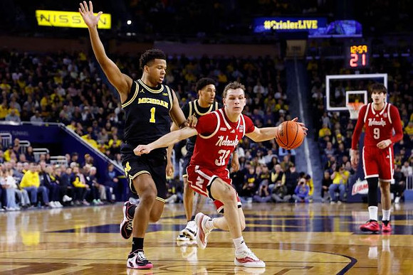 Trey McKenney (1) and Yaxel Lendeborg (23)