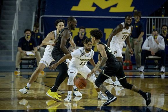 Brandon Johns Jr. (23), Mike Smith (12), and Chaundee Brown Jr. (15)