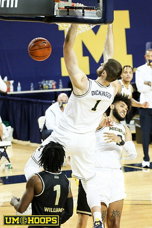 Hunter Dickinson (1), Isaiah Livers (2), and Terrance Williams II (5)