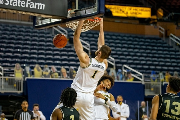 Hunter Dickinson (1) and Isaiah Livers (2)