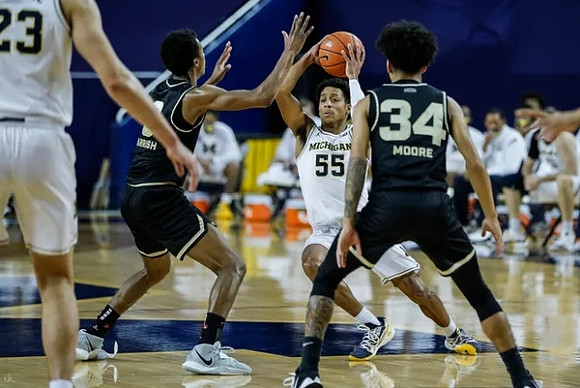 Brandon Johns Jr. (23) and Eli Brooks (55)