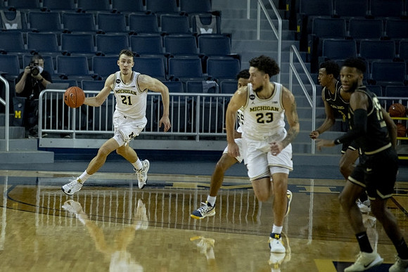 Franz Wagner (21), Eli Brooks (55), and Brandon Johns Jr. (23)
