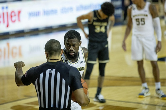 Chaundee Brown Jr. (15) and Eli Brooks (55)