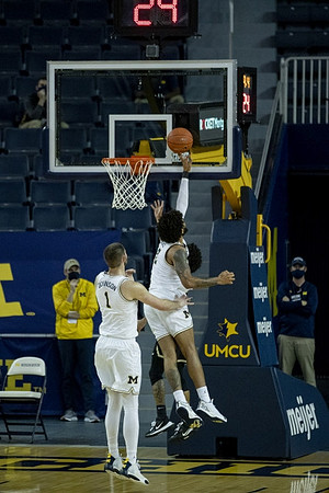 Hunter Dickinson (1) and Isaiah Livers (2)