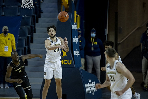 Brandon Johns Jr. (23), Franz Wagner (21), and Isaiah Livers (2)