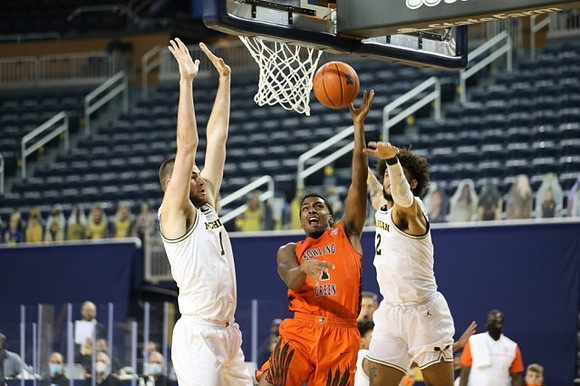 Hunter Dickinson (1) and Isaiah Livers (2)