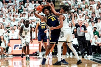 Yaxel Lendeborg (23), Morez Johnson Jr. (21), and Michigan State Head Coach Tom Izzo