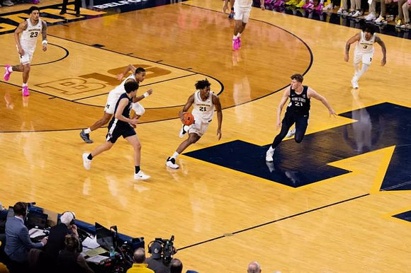 Yaxel Lendeborg (23), Nimari Burnett (4), Morez Johnson Jr. (21), and Elliot Cadeau (3)