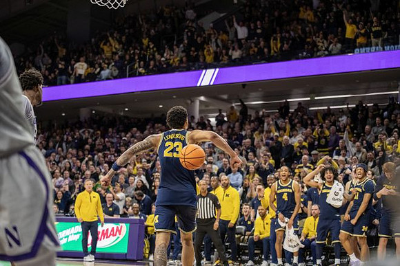 Yaxel Lendeborg (23), Dusty May, and Michigan Team