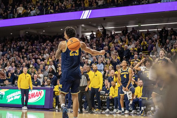 Yaxel Lendeborg (23), Dusty May, and Michigan Team