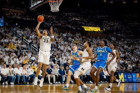 Yaxel Lendeborg (23), Nimari Burnett (4), and Morez Johnson Jr. (21)