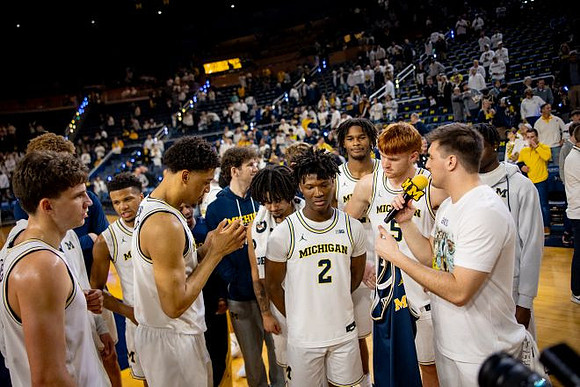 L.J. Cason (2) and Michigan Team