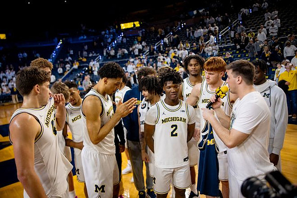 L.J. Cason (2) and Michigan Team